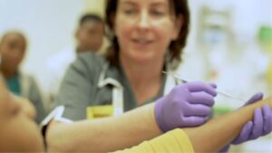 Nurse supporting young patients at Evelina London Children's Hospital.