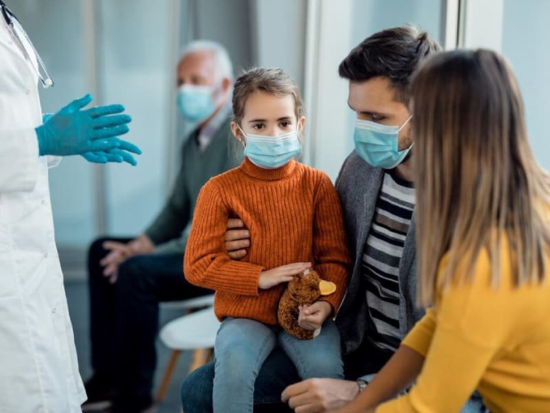 Miss Torres-Grau examining a child's hand at first appointment