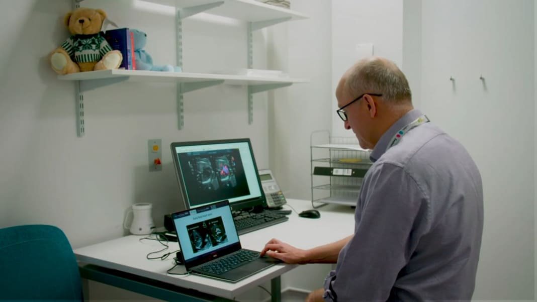 A photo of a consultant looking at scan photos