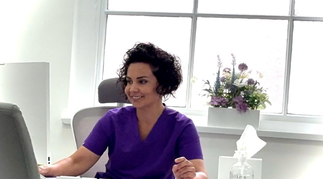 Miss Jana Torres-Grau at her desk during a children's plastic surgery consultation